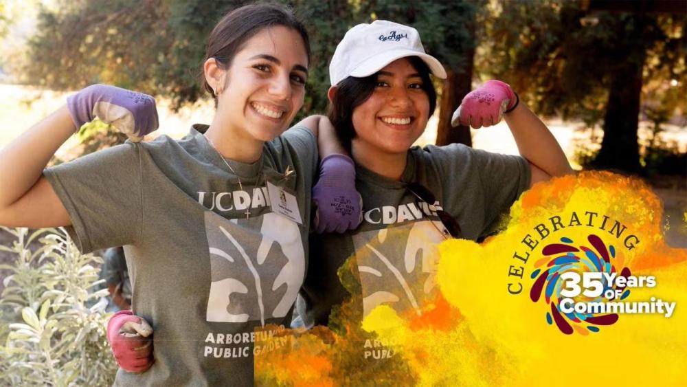 Two women wearing UC Davis Arboretum t-shirts each raise one arm to show strength. Their other arm is linked around the other person's waist. in corner of image is spiral of colors with Celebrating 35 years over a golden watercolor graphic.