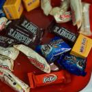 Various small pieces of candy in a basket—Hershey, Kit Kat, and others.