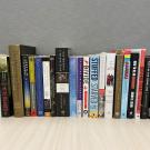 Book spines of the Campus Community Book Project selections from 2002 to 2025